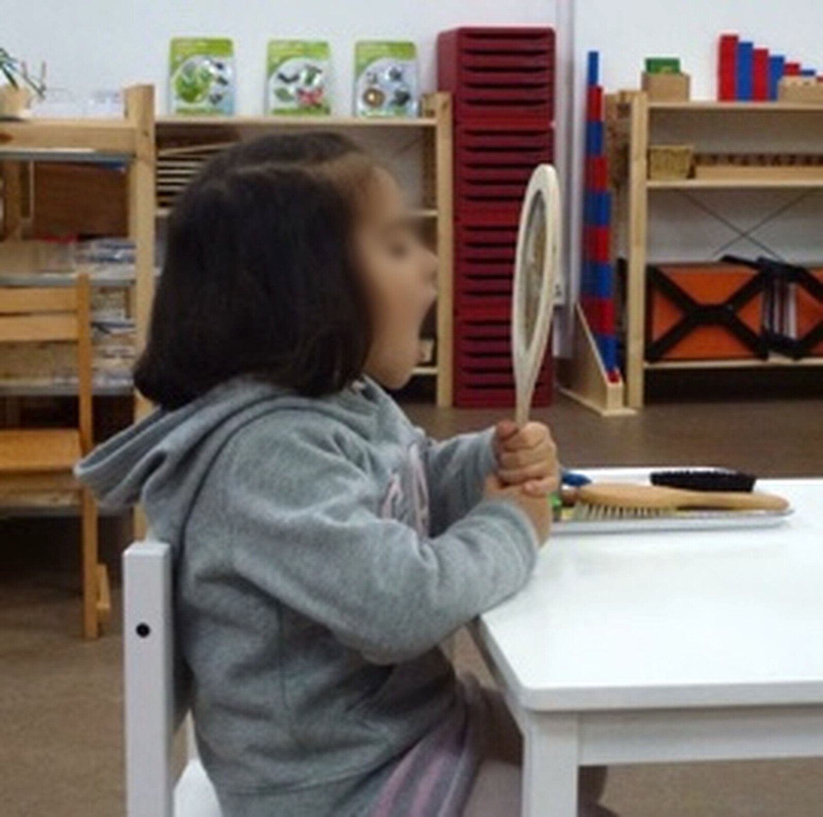 Child with a hand mirror