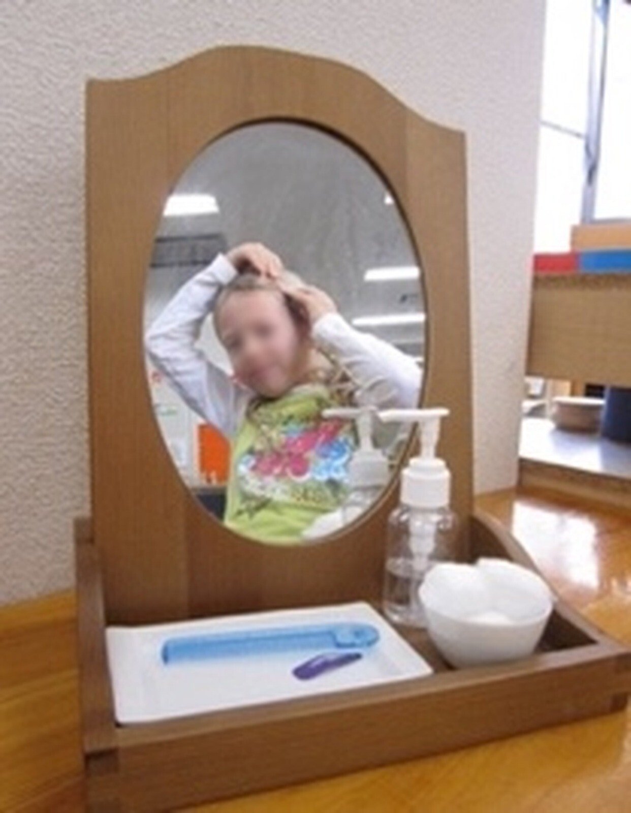 Child at a standing mirror