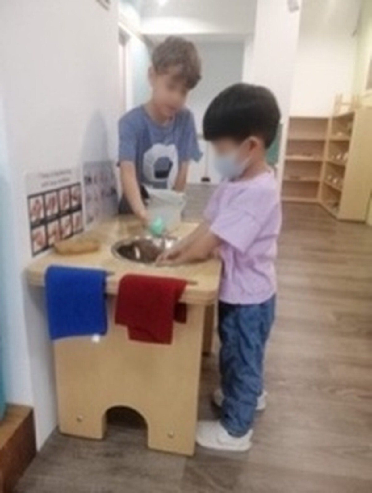 Children at a hand washing stand