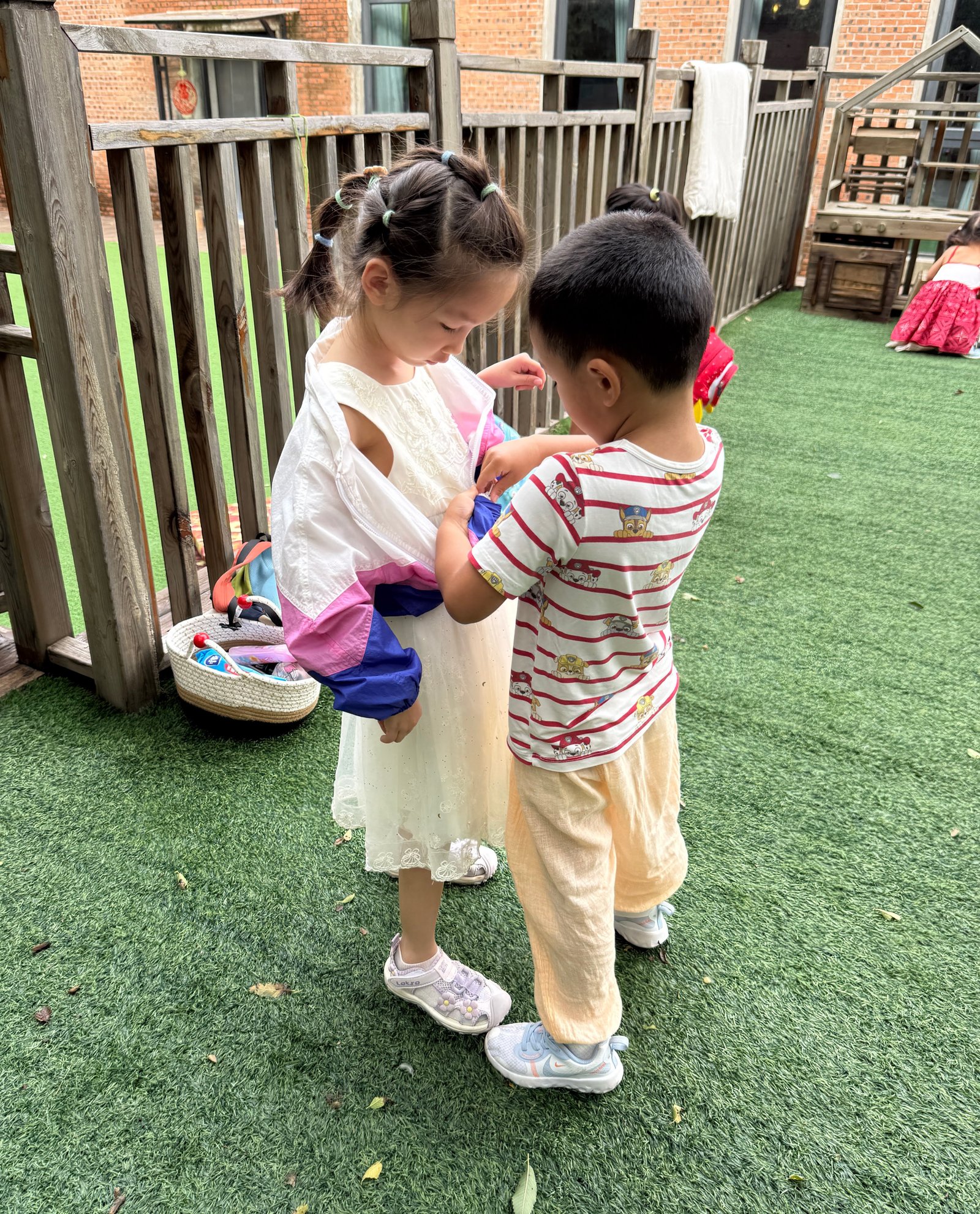 Children hanging a cloth